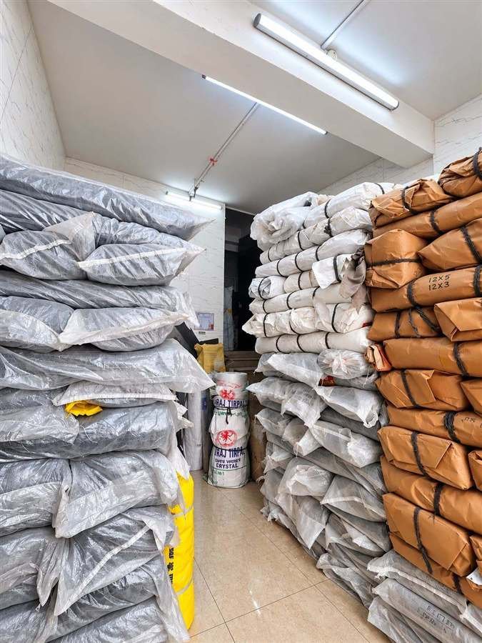 Packed tarpaulin stock inside the Girdhar Brothers shop